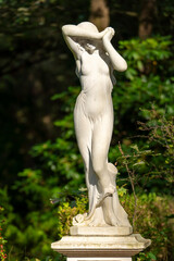 white marble statue of a woman in the park 