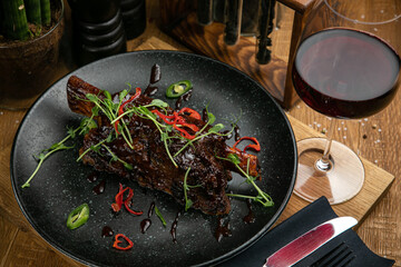 Grilled meat from the menu of an Italian restaurant. On a wooden table
