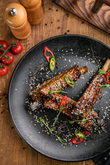 Grilled meat from the menu of an Italian restaurant. On a wooden table
