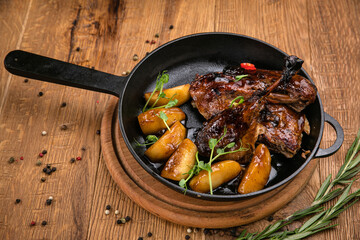 Grilled meat from the menu of an Italian restaurant. On a wooden table
