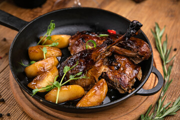 Grilled meat from the menu of an Italian restaurant. On a wooden table
