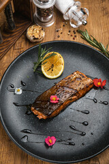 Grilled fish from the menu of an Italian restaurant. On a wooden table
