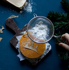 New year's holiday cake on a wooden Board with powdered sugar. Cooking. Templates for baking. High...