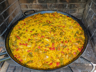 Typical Spanish paella resting on the coals