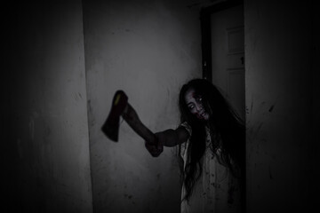 Portrait of asian woman make up ghost face,Horror scene for wallpaper,Scary Halloween festival concept,Ghost holding axe