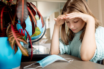Naklejka premium Girl 10 years old on distance learning at home