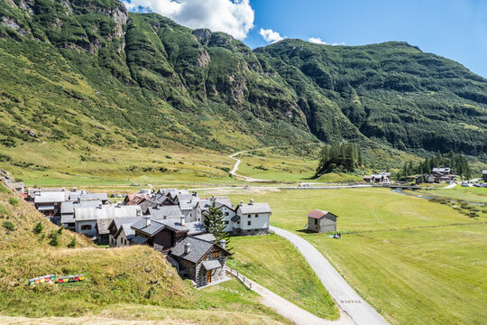 small village in the mountains with stone houses, flowers and a river in val formazza