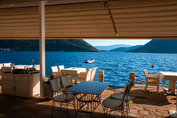 Perast city embankment with cafes and boats in the adriatic sea