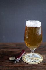 cold beer stands on a wooden table