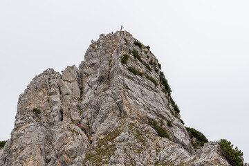 The mountain Schartschrofen in Austria with the via ferrate and climbers in the wall.