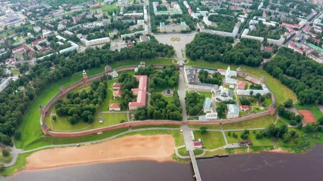 Panoramic aerial view of the Volkhov River and the old town of Veliky Novgorod, the red brick Kremlin in the rays of the setting sun and natural attractions of Russia.