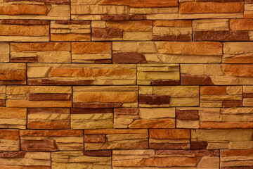 background of orange brick wall. Stone facing. Old yellow bricks