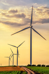 Renewable energy with wind farm turbines and generators in the sunset, beautiful landscape 