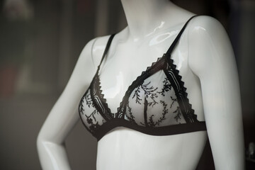 Closeup of black transparent bra on mannequin in fashion store showroom