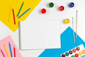 Learning, hobby, art background. Empty sketchbook with art supplies around. Mockup. Top view, flat...