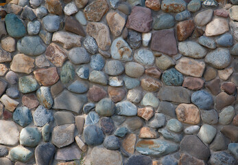 background surface of the cobblestone wall, road paved with cobblestones