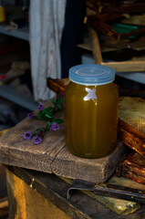 Jar of honey. Honey and honeycombs in the apiary. Beekeeper's workshop. Tools for honey extraction. Apiary. Extraction of honey. Beekeeper's tools. Honey production.