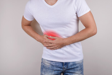 Cropped close up photo portrait of unhappy sad upset guy holding touching right side wearing casual...