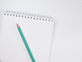 Notepad with a pencil lying on a light table