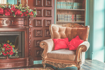 Luxury classic interior of home library. Sitting room with bookshelf, books, arm chair, sofa and fireplace. Clean and modern decoration with elegant furniture. Education read study wisdom concept.