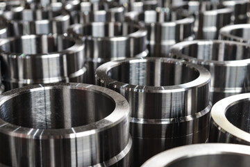 Round metal products made on a lathe. Metalworking of parts at the factory.