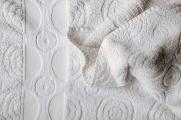 Macro close-up of a white towel with circle shapes and with fold