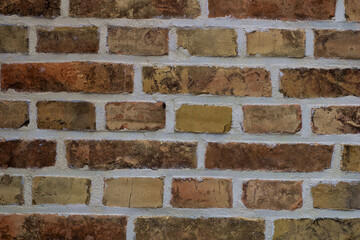 Texture of old brick wall with multicolored bricks