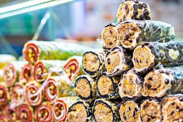 Various bright colored turkish delights sweets baklava lokum and dried fruits vegetables on market in Istanbul, Turkey