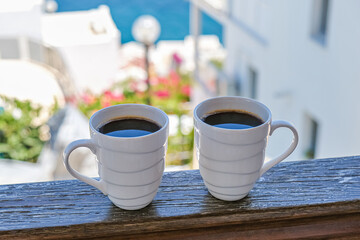 two coffee cup coffee cups in wooden balcony terrace with sea view