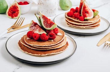 Homemade classic american pancakes with almond, fresh raspberries and figs