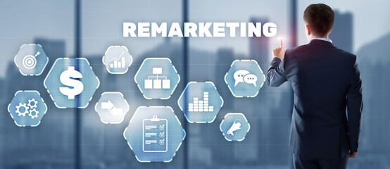 Remarketing digital marketing concept. Businessman presses remarketing on virtual screen.