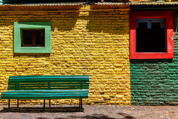 Bench in front of a colorful wall in the Caminito area, in the Buenos Aires neighborhood of La Boca
