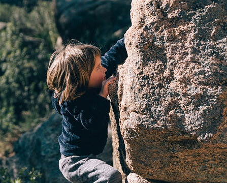Cute Little Girl Climbing Rock