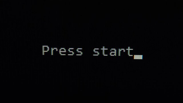 Typing of phrase Press start on black screen close up view 4K. Retro Videogame Press Start Text Computer.