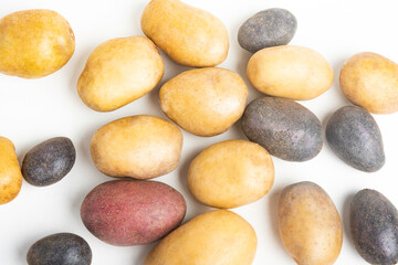 Fototapeta na wymiar Assorted Color Potatoes On Flat White Surface Table