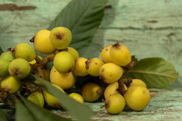 Medlar fruit (Eriobotrya japonica) on aged wooden background