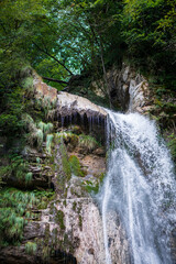Fototapeta na wymiar small mountain waterfall in the alps