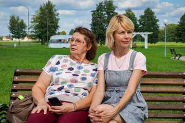 Two nice Mature women relax in a Park.