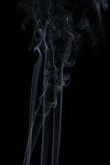 White smoke from incense on a black background