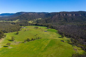 Fototapeta na wymiar A lush green agricultural valley in The Blue Mountains in Australia