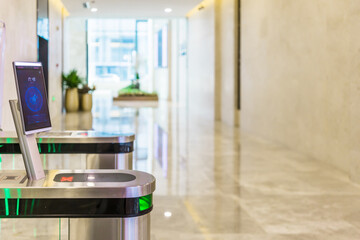 turnstile gate in office building with digital facial scaner.