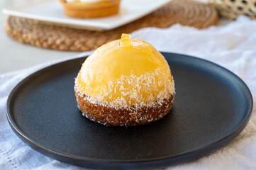 Small yellow  lemon ball tart from French pastry shop