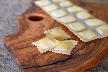 Handmade uncooked fresh ravioli with four cheeses filling, tasty vegetarian food