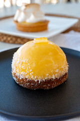 Small yellow  lemon ball tart from French pastry shop