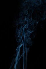 blue smoke from incense on a black background