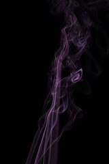 Obraz premium purple smoke from incense on a black background