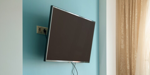 modern tv with empty black lcd screen hanging on blue wall of home room