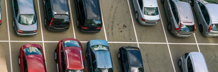 aerial view on parking lot of diferent cars on asphalt places near office or supermarket