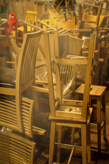 Photo of a furniture warehouse . A mountain of wooden chairs.
