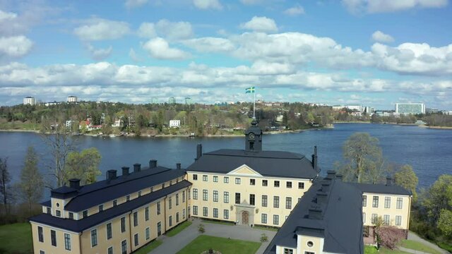 Swedish Castle Palace and Flag in aerial drone shot. Flight close to Sweden flag